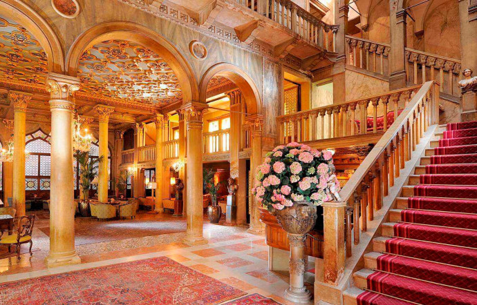 Le hall de l’hôtel vous accueille dans un décor riche, où boiseries, antiquités et verre de Murano sont omniprésents.