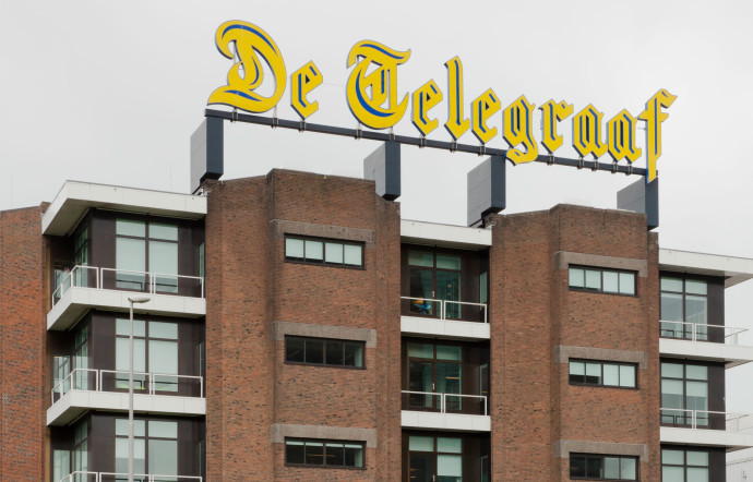 Deux immeubles de verre, situés à proximité du port d’Amsterdam, accueillent les 600 salariés De Telegraaf Media Groep. Sur les disques bleus, sont listés les noms des titres du groupe.
